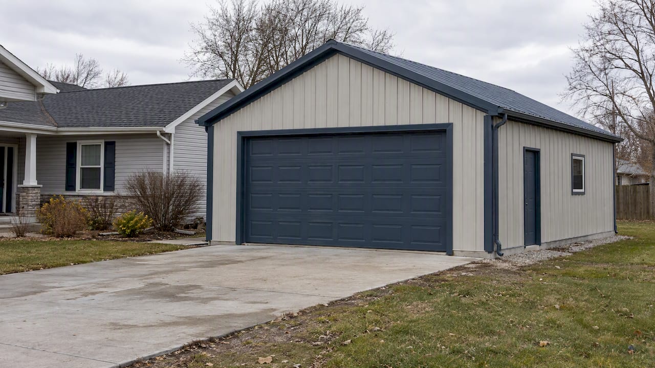 Two-tone metal garage beside a home