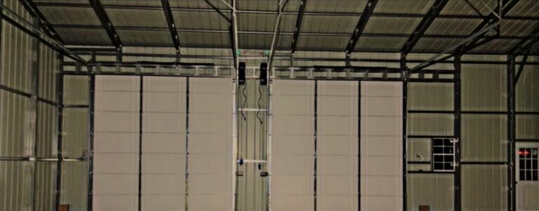 Wide interior view of a steel building frame with wall panels installed