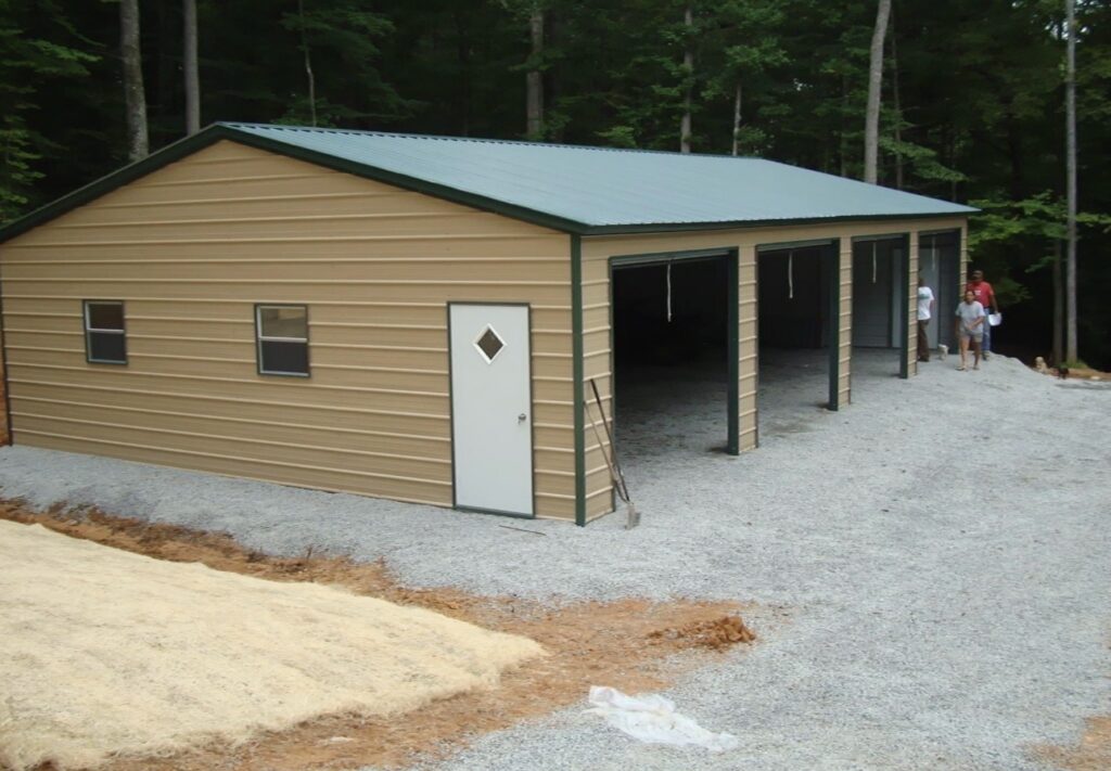 Tan metal building with green roof and attached open lean-to