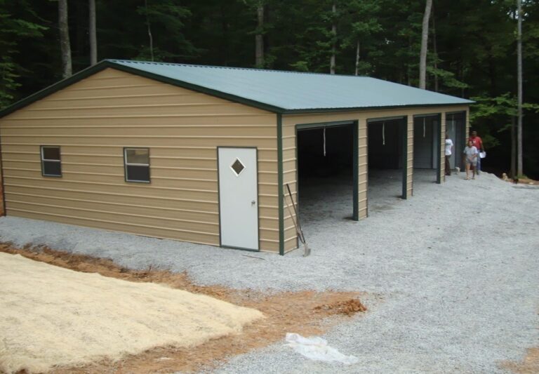 Tan metal building with green roof and attached open lean-to