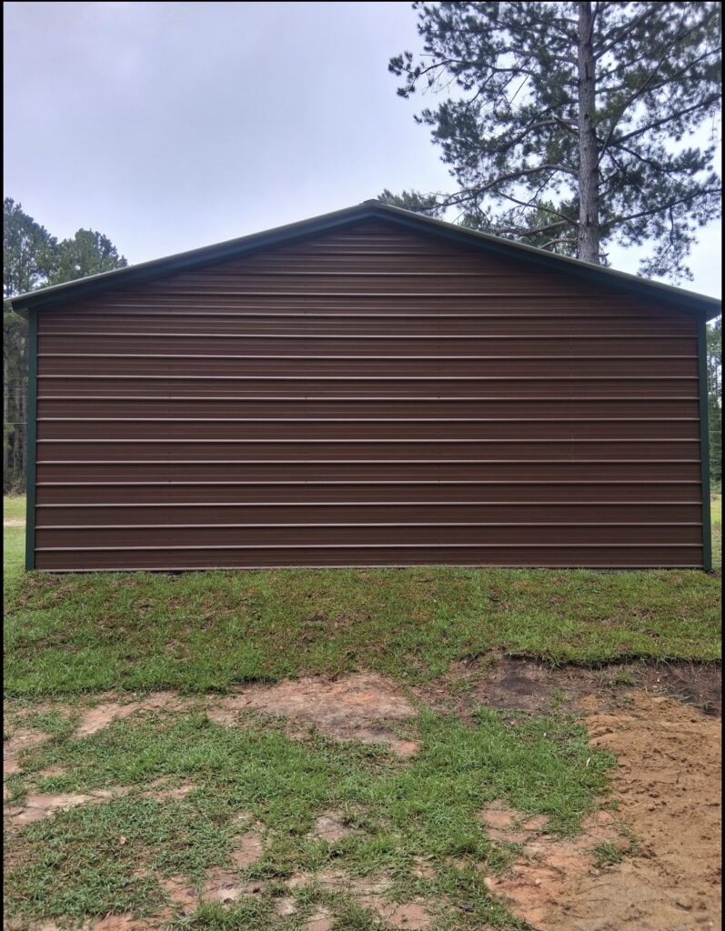 Dark brown metal building with vertical roof panels