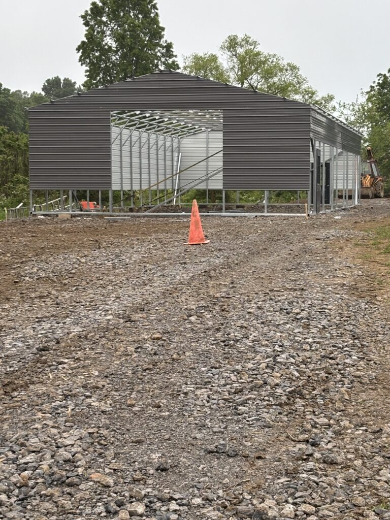 Dark gray steel building on a finished gravel pad