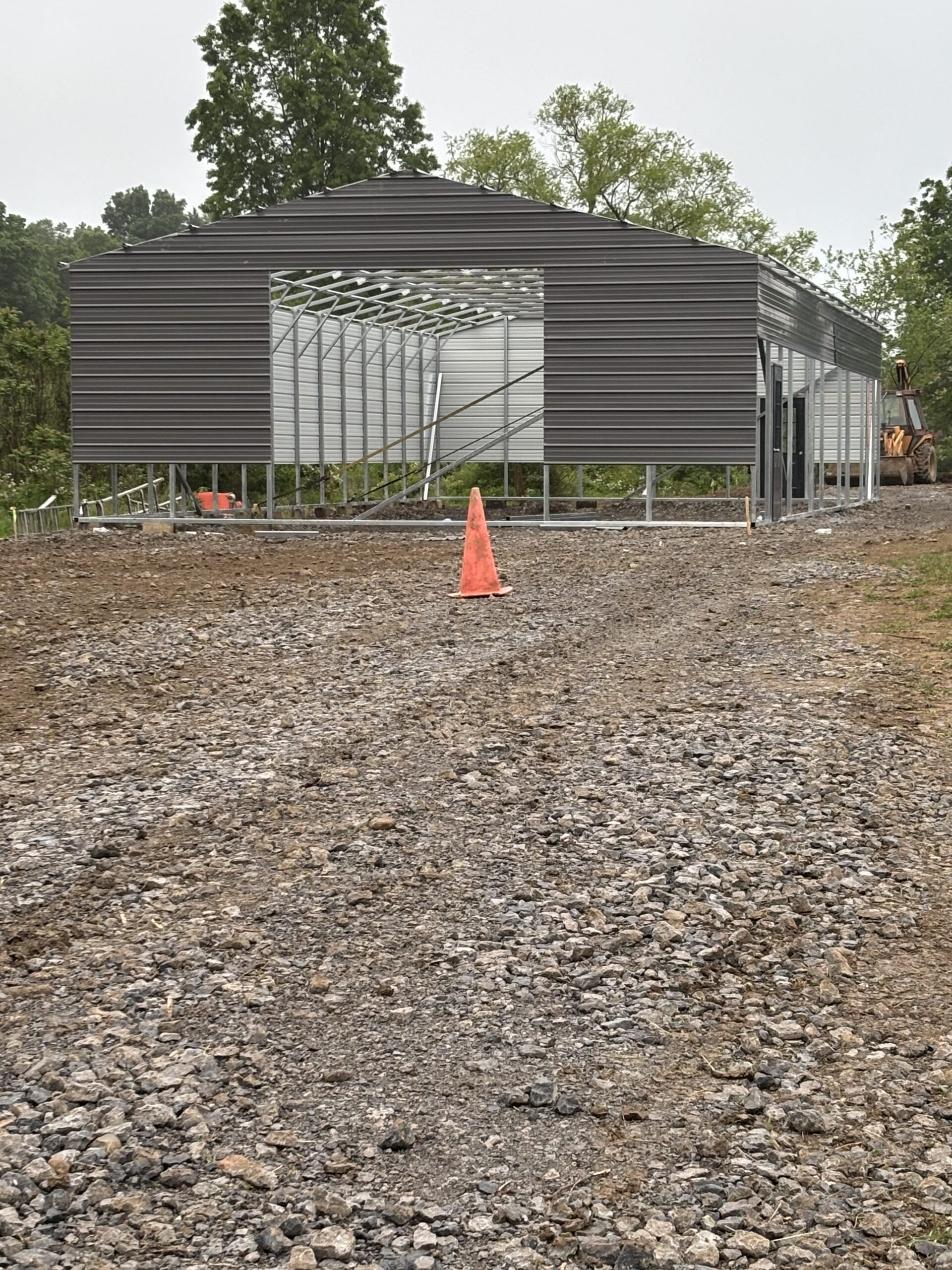 Dark gray steel building on a finished gravel pad