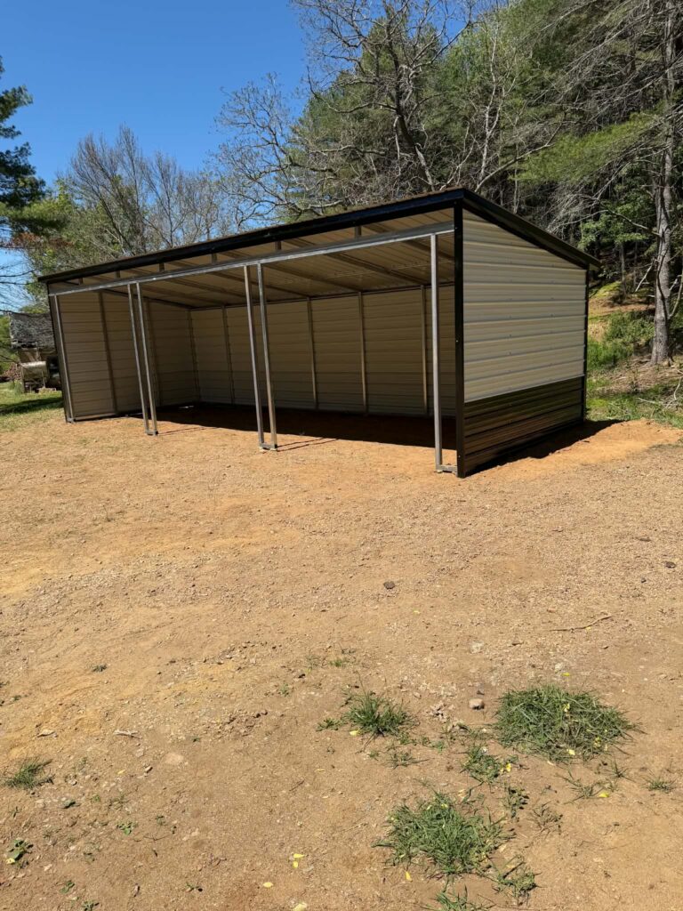 Brown metal carport with closed sides on a freshly graded lot